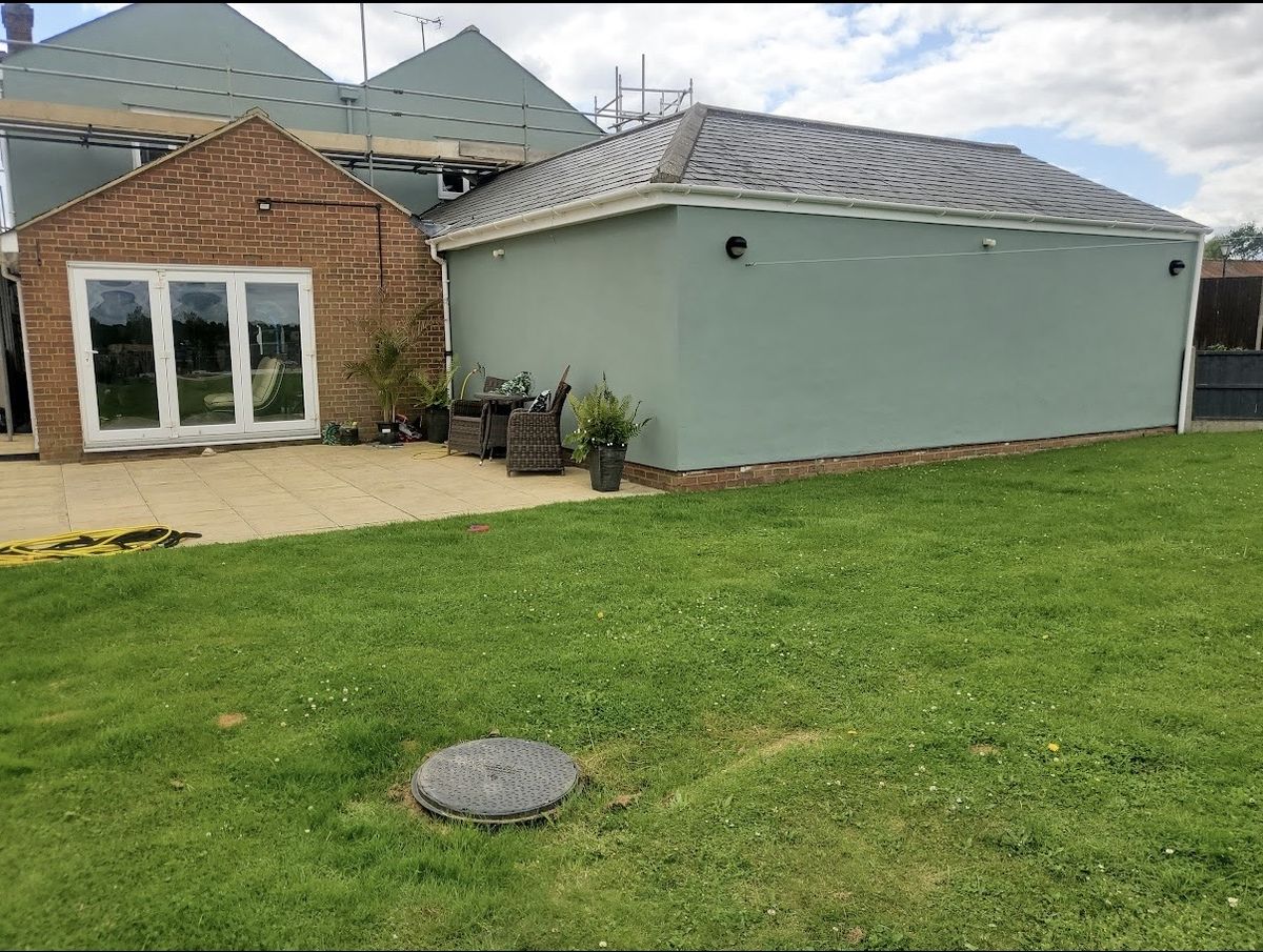 Rear elevation, render finished in sage green