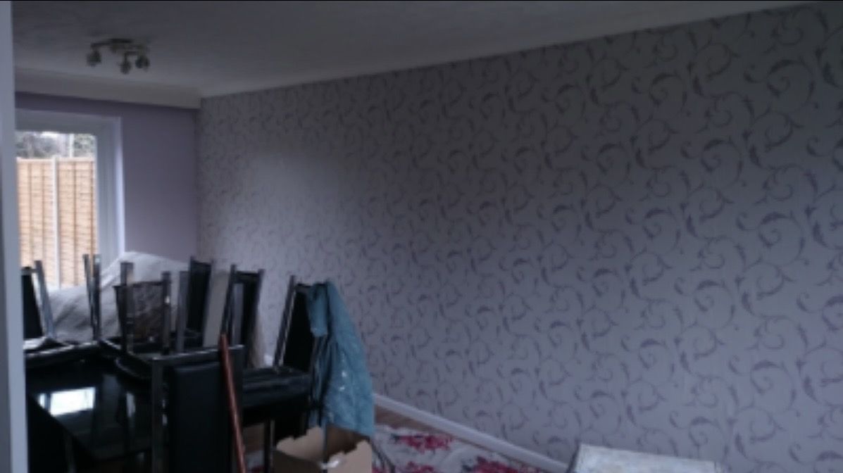 Dining room with a patterned feature wallpaper